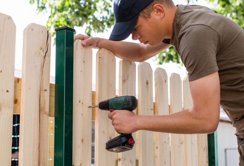 Handyman performing fence work